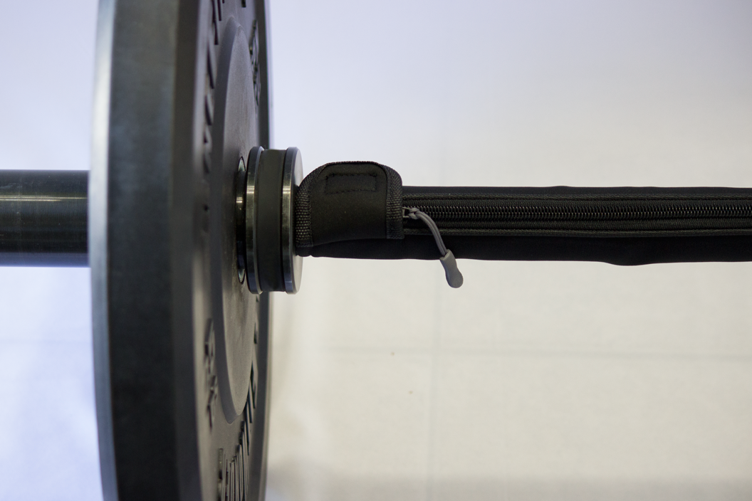 Barbell warmer wrapped around barbell close up view of bounce plates for weightlifting